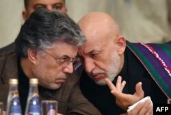 Former Afghan president Hamid Karzai attends the opening of two-day talks between Taliban and Afghan opposition representatives, at the President Hotel in Moscow, Russia, Feb. 5, 2019.