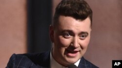 FILE - Sam Smith accepts the award for record of the year for “Stay With Me” at the 57th annual Grammy Awards, Feb. 8, 2015.