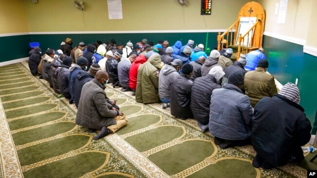 Members of the Masjid Ar Rahman pray, in the Bronx borough of New York, Jan. 12, 2022. The mosque is a place of worship for some of the residents of the building, site of New York City's deadliest fire in three decades.