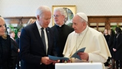 President Joe Biden exchanges gifts with Pope Francis as they meet at the Vatican, Oct. 29, 2021.