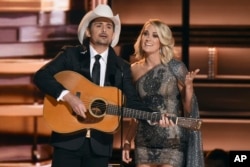 Hosts Brad Paisley, left, and Carrie Underwood speak at the 50th annual CMA Awards at the Bridgestone Arena in in Nashville, Tennessee, Nov. 2, 2016.