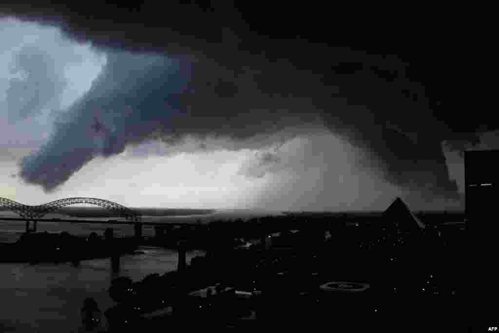 May 25: A line of severe storms crosses the Mississippi River in Memphis, Tenn., passing by the Memphis Pyramid. The dark formation was reported a few minutes earlier as a tornado in West Memphis, Ark. (AP Photo)