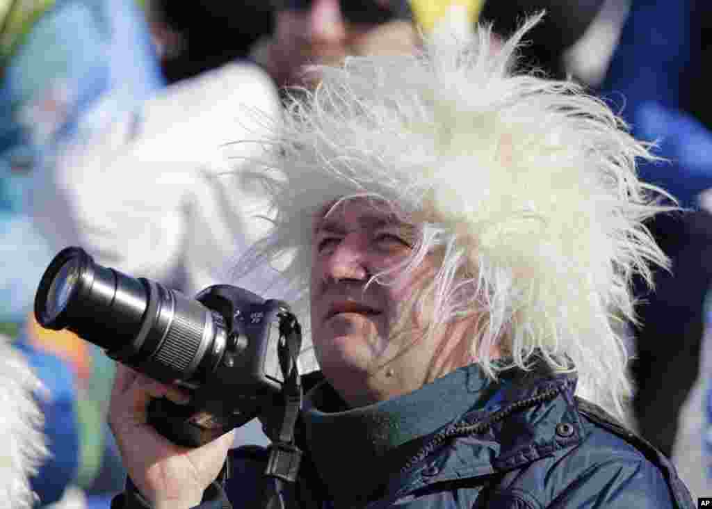 A spectator wears a fuzzy hat as he watches athletes compete in the downhill portion of the women&#39;s supercombined,&nbsp;Krasnaya Polyana, Russia,&nbsp;Feb. 10, 2014.