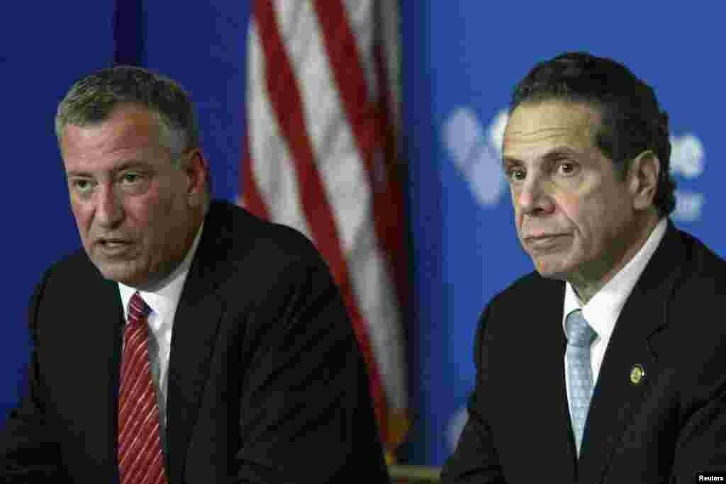 New York City Mayor Bill de Blasio (left) and New York Gov. Andrew Cuomo discuss the city&#39;s first confirmed Ebola case at a news conference at Bellevue Hospital, New York City, Oct. 23, 2014. 
