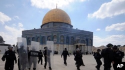 FILE - Israeli forces take position during clashes with Palestinian worshippers at the al-Aqsa compound — known to Jews as Temple Mount — in Jerusalem's Old City, Oct. 5, 2012.