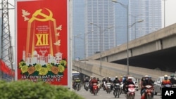 Vehicles drive past a sign marking the 12th Congress of the Communist Party of Vietnam in Hanoi, Vietnam, Jan. 19, 2016. This week, representatives of Vietnam's Communist party gather in the capital to pick the country's new leaders. 