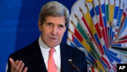 Secretary of State John Kerry gestures as he speaks at the Organization of American States (OAS) in Washington, Nov. 18, 2013