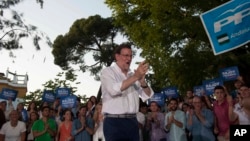 Spain's acting Prime Minister and Popular Party candidate, Mariano Rajoy applauds in front of party supporters during a campaign rally in Seville, Spain, Thursday June 23, 2016.