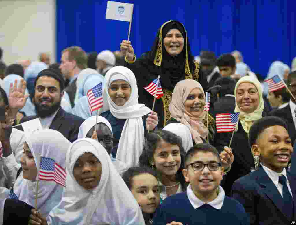 Children from Al-Rahmah school and other guests react after seeing President Barack Obama during his visit to the Islamic Society of Baltimore, Feb. 3, 2016.