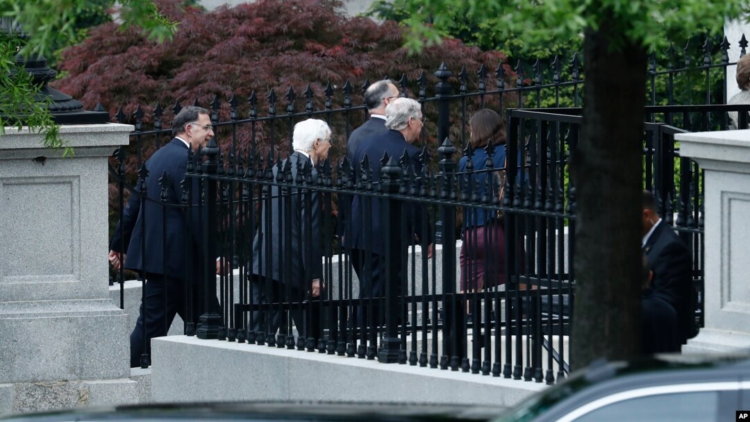 Senate Majority Leader Mitch McConnell (center) and other senators walk to an all-Senators briefing on the situation in the Korean Pensinsula, April 26, 2017, at the Eisenhower Executive Office Building on the White House complex in Washington.