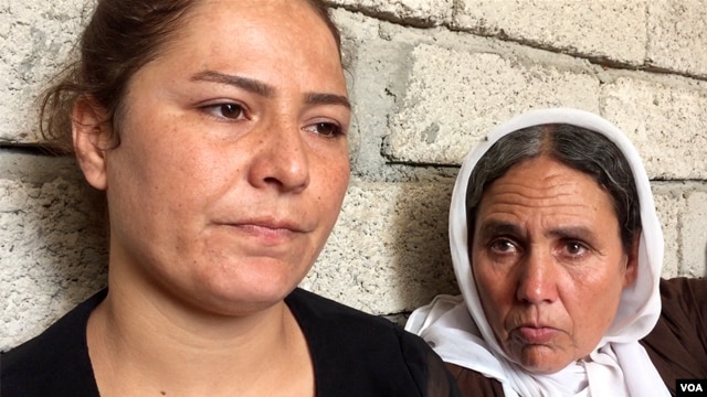 Alia looks on while her mother speaks to a VOA reporter pleading that the international community helps rescue the rest of the captive Yazidi men, women and children, including her other daughters, on the outskirts of Dohuk, northern Iraq, Aug. 2015. (Sharon Behn/VOA)