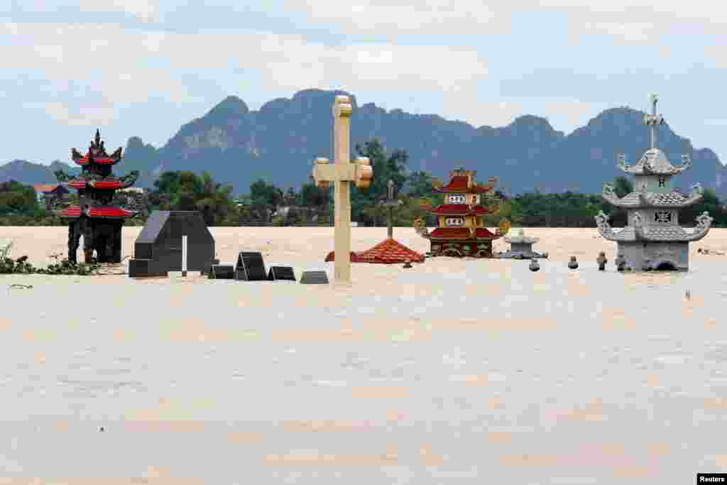 Submerged tombs are seen at a flooded village after heavy rainfall caused by tropical storm Son Tinh in Ninh Binh province, Vietnam.