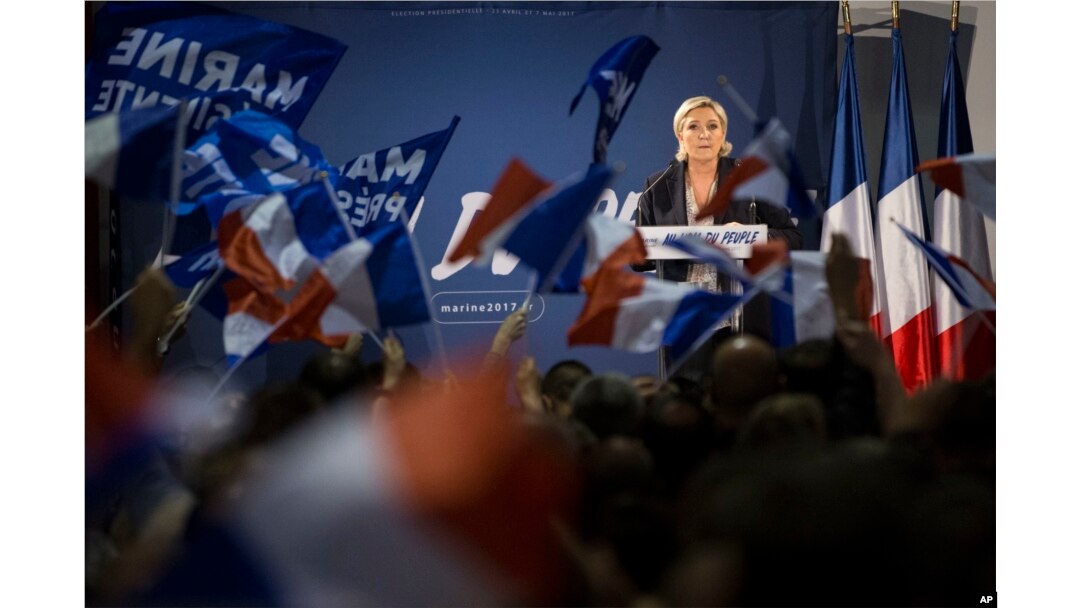 FILE - Far-right candidate for the presidential election Marine Le Pen speaks during a campaign meeting in Arcis-sur-Aube, near Troyes, France, April 11, 2017. Le Pen argues that Muslim immigration and economic globalization are destroying France's identity.