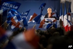 FILE - Far-right candidate for the presidential election Marine Le Pen speaks during a campaign meeting in Arcis-sur-Aube, near Troyes, France, April 11, 2017. Le Pen argues that Muslim immigration and economic globalization are destroying France's identity.