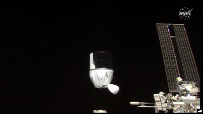 FILE- This photo provided by NASA shows SpaceX's Dragon undocking from International Space Station on Tuesday, Jan. 12, 2021. 