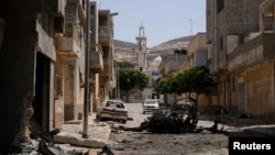 A view of destroyed buildings and cars after the street was controlled by forces loyal to Libyan commander Khalifa Haftar in Derna, Libya, June 13, 2018. 