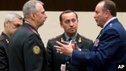 NATO's Supreme Allied Commander Europe U.S. General Philip M. Breedlove (R) speaks with Ukraine's acting Defense Minister Mykhailo Koval (2nd L) during a meeting of NATO defense ministers in the format of the North Atlantic Council with Non-ISAF contribut