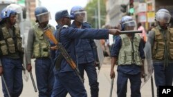 FILE: Police officers stand by as opposition party supporters gathered to hear a speech by the country's top opposition leader in Harare.
