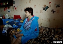 Local resident Alexandra Nikolayevna, 68, sits in her house in Donetsk, Ukraine, Sept. 28, 2017.