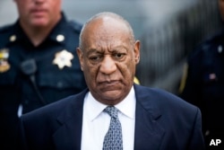 Bill Cosby departs a Pennsylvania courthouse after a hearing in his sexual assault case. No decision was reached and he will be retried next year.
