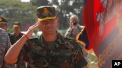 Lt. Gen. Hun Manet, son of Cambodian Prime Minister Hun Sen and deputy commander of the Royal Cambodian Army and commander of the National Counter Terror Special Force, walks through honorary guards as his arrives for presiding over a U.S.-backed peacekeeping exercise dubbed "Angkor Sentinel 2014" at the Cambodian tank command headquarters in Kampong Speu province, 60 kilometers (37 miles) west of Phnom Penh, Cambodia, Monday, April 21, 2014. (AP Photo/Heng Sinith)