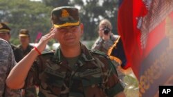 Lt. Gen. Hun Manet, son of Cambodian Prime Minister Hun Sen and deputy commander of the Royal Cambodian Army and commander of the National Counter Terror Special Force, walks through honorary guards as his arrives for presiding over a U.S.-backed peacekee