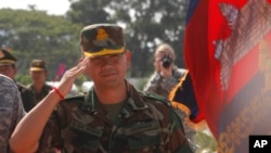 FILE PHOTO - Lt. Gen. Hun Manet, son of Cambodian Prime Minister Hun Sen and deputy commander of the Royal Cambodian Army and commander of the National Counter Terror Special Force, walks through honorary guards as his arrives for presiding over a U.S.-backed peacekeeping exercise dubbed "Angkor Sentinel 2014" at the Cambodian tank command headquarters in Kampong Speu province, 60 kilometers (37 miles) west of Phnom Penh, Cambodia, Monday, April 21, 2014. (AP Photo/Heng Sinith)