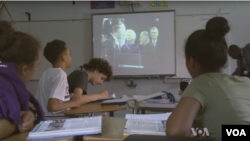 Students watching a campaign video in their middle school civics class