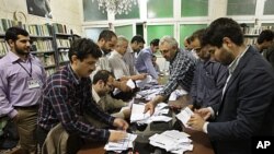 Electoral workers count ballots in a polling station, in Tehran, Iran, May 4, 2012. 