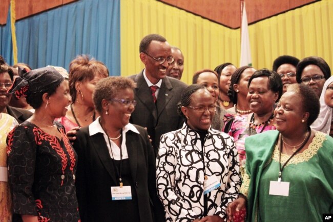 FILE - Rwandan President Paul Kagame, centre, takes part in a group photo at a conference on the role of women at the nation's parliament, May 17, 2010.