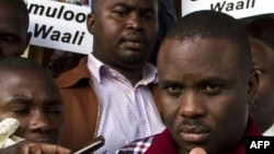 FILE - Kampala Lord Mayor Erias Lukwago (R) address the media outside the Buganda Magistrates court, Uganda.