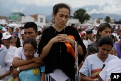 A woman prays during Mass celebrated by Pope Francis in Villavicencio, Colombia, Sept. 8, 2017.