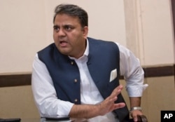 In this Sept. 25, 2018 photo, Pakistani Information Minister Fawad Chaudhry speaks to The Associated Press, in Islamabad.