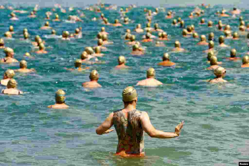 People take part in the yearly public Lake Zurich crossing swimming event in Zurich, Switzerland, July 11, 2018.