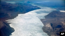 Icebergs float into a fjord off the Greenland ice sheet in southeastern Greenland, Aug. 3, 2017. The Greenland ice sheet, the second largest body of ice in the world which covers roughly 80 percent of the country, has been melting and its glaciers retreating at an accelerated pace in recent years due to warmer temperatures. 