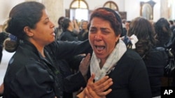 A Coptic Christian woman grieves during the funeral for victims of clashes between Muslims and Christians in Cairo, May 8, 2011