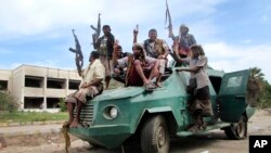 Militiamen loyal to President Abed Rabbo Mansour Hadi ride on an army vehicle on a street in Aden, Yemen, March 20, 2015.