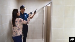 Police officers investigate the facilities at the national training center in Jincheon, South Korea, Aug. 29, 2016. The head coach of South Korea's national swimming team resigned Aug. 31, 2016, as police investigate allegations that two male swimmers secretly filmed female swimmers after installing a spy camera in their locker room at a training facility in 2013.