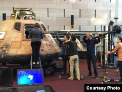 Specialists using special 3-D technology to scan the interior of the Apollo 11 Command Module, (National Air and Space Museum).