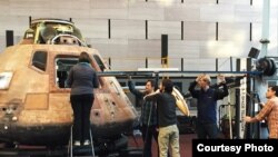 Scientists using special 3D technology to scan the interior of the Apollo 11 Command Module, (National Air and Space Museum).