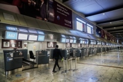International check-in counters stand empty as several airlines stopped flying out of South Africa, amidst the spread of the new SARS-CoV-2 variant Omicron, at O.R. Tambo International Airport in Johannesburg, South Africa, Nov. 28, 2021.