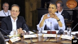 French President Francois Hollande, left, listens as U.S. President Barack Obama speaks at the start of the first working session of the G8 Summit at Camp David, Md., May 19, 2012. 