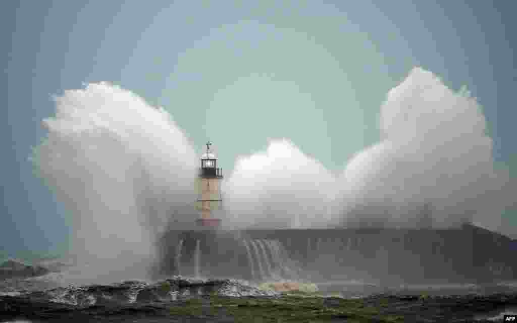 Waves crash over Newhaven Lighthouse on the south coast of England, United Kingdom, as Storm Ciara swept over the country.