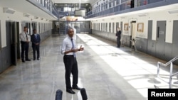 FILE - U.S. President Barack Obama, shown visiting the El Reno Federal Correctional Institution in Oklahoma in July, is pressing for more support for prisoners re-entering society. 