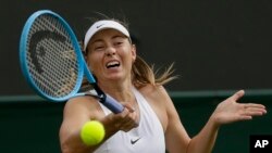 Russia's Maria Sharapova returns to Pauline Parmentier of France in a Women's singles match during day two of the Wimbledon Tennis Championships in London, July 2, 2019. 