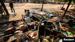 Destroyed furniture and belongings are seen in a market in Sit Kwin, Burma, March 29, 2013. 