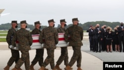 U.S. President Joe Biden and first lady Jill Biden salute during the dignified transfer of the remains of US military service members who were killed by a suicide bombing at Kabul Airport, at Dover Air Force Base, Aug. 29, 2021. 