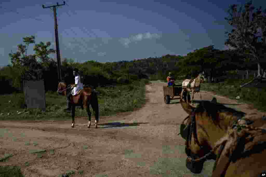 Medical student Hector Manuel Batista rides a horse in search of residents in the countryside who may be infected with the new coronavirus, in San Jose de las Lajas, Cuba, April 30, 2020. 