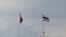 Cambodian and Thai flag poles on the Gulf of Thailand at Koh Kong-Trat border crossing between the two countries. The new visa exemption agreement raises hopes of increased trade and tourism between the two neighbors.