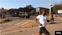 FILE: Protesters are seen running from members of the army, in Harare, Zimbabwe, Aug. 7, 2018. On Tuesday, embassies of the European Union, the U.S., Canada and Switzerland in Harare issued a statement expressing concern over “excessive use of force" by Zimbabwe.